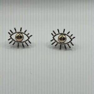 Silver eye-shaped earrings with gold-colored center